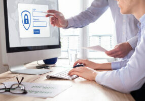Cyber security concept with manager providing authentication credentials (login, password) to business person to access confidential data on computer screen